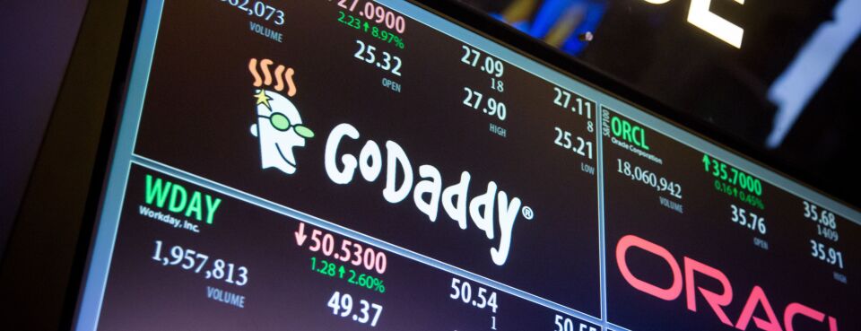 Trading information about GoDaddy Inc. is displayed on a monitor on the